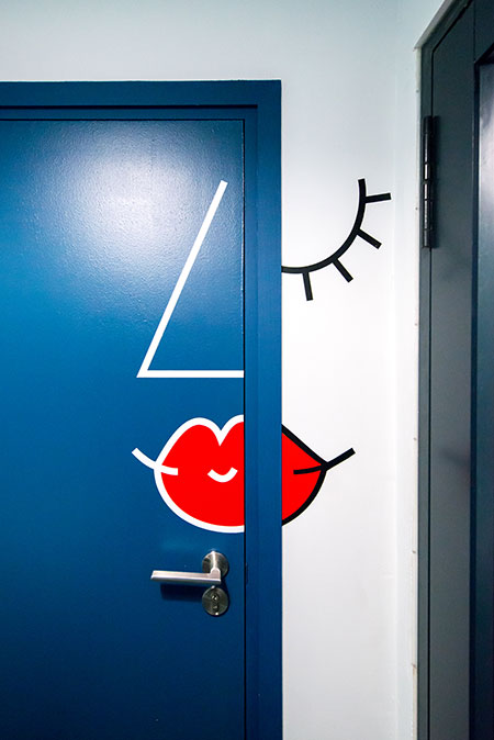 HOME-DZINE | Interior Design - Allport offices - The bathroom area is a particularly creative: the women’s restroom door features a Picasso-esque depiction of a feminine face and on the right is a shower room, indicated by a simple shower illustration. 