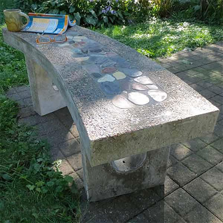 Concrete bench with pebble inlay