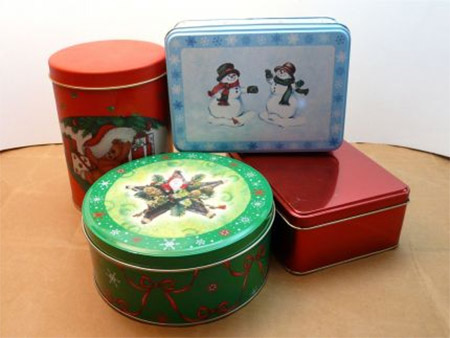Many stores sell Christmas goods in tins, and here's a way to turn these into practical and pretty storage containers.