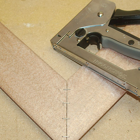 use a heavy-duty stapler to secure frame corners