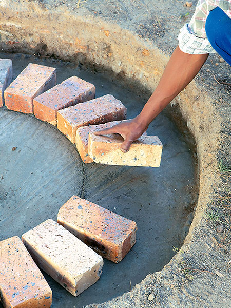 lay first row of bricks for firepit