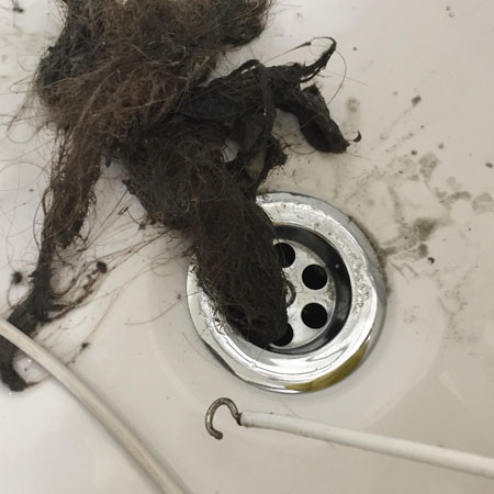 hooked curtain wire removes hair in drains