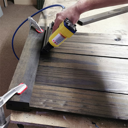 use pneumatic nailer to secure wood planks