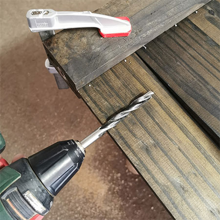 drill hole to insert rebar into fence panel