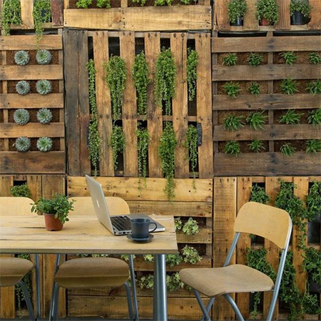 disguise concrete or brick wall with wood pallets
