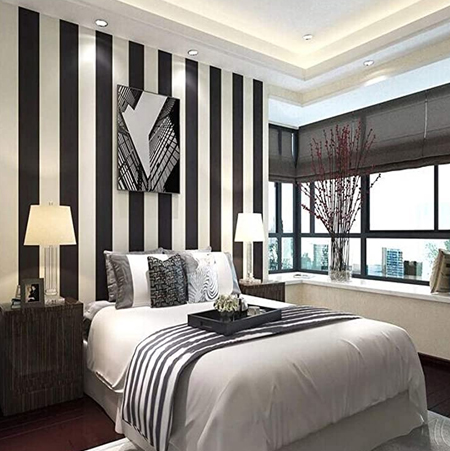 striped wallpaper above the bed